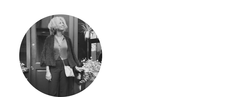 a woman standing in a circle with a purse on her shoulder